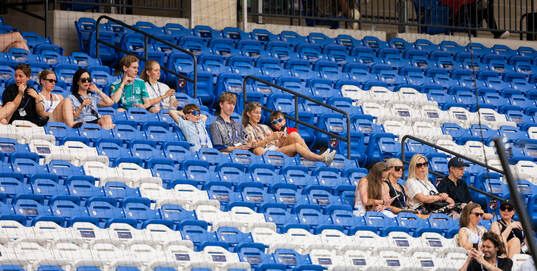Familys in the stands at a training session with the