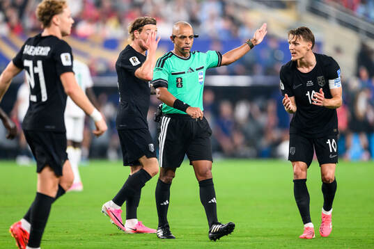 Referee Wilton Sampaio and Martin Ødegaard of Norway