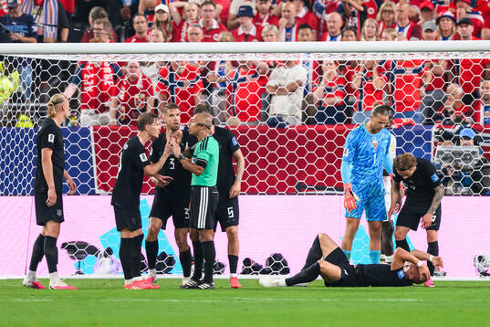 Leo Østigård of Norway in pain as Martin Ødegaard and