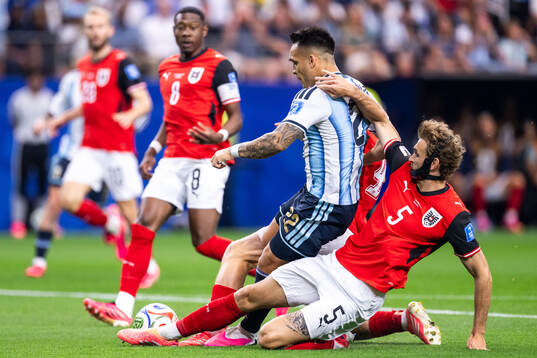 Lautaro Martinez of Argentina and Stefan Posch of Austria