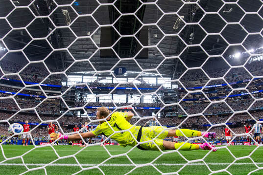 Goalkeeper Alexander Schlager of Austria saves a penalty