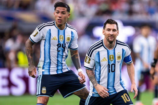 Enzo Fernandez and Lionel Messi of Argentina