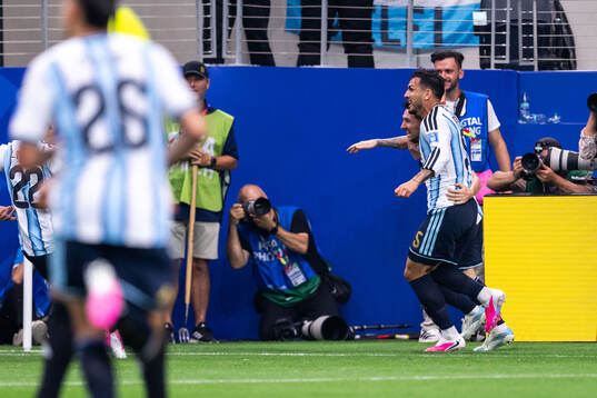 Lionel Messi of Argentina celebrates with Leandro Paredes