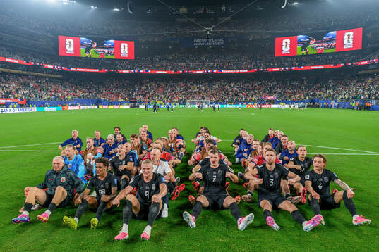 Players and staff of Norway celebrate with a viking row