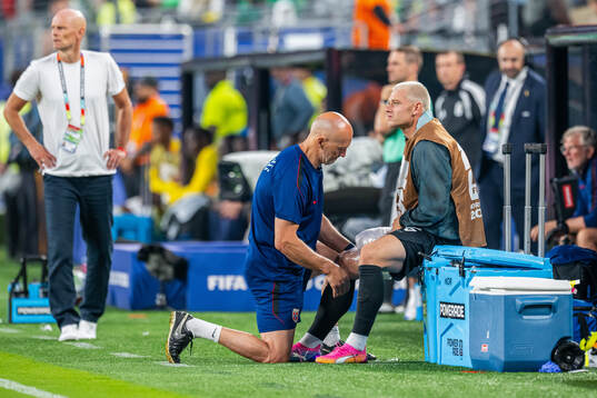 Julian Ryerson of Norway receives treatment from manual