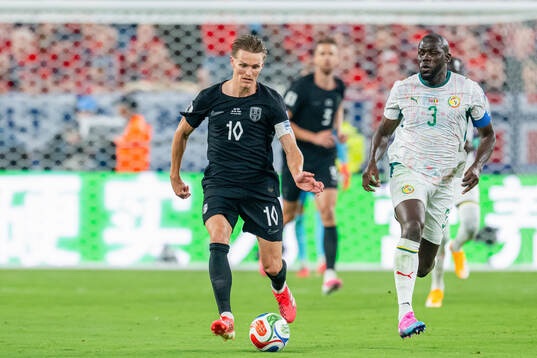 Martin Ødegaard of Norway and Kalidou Koulibaly of Senegal