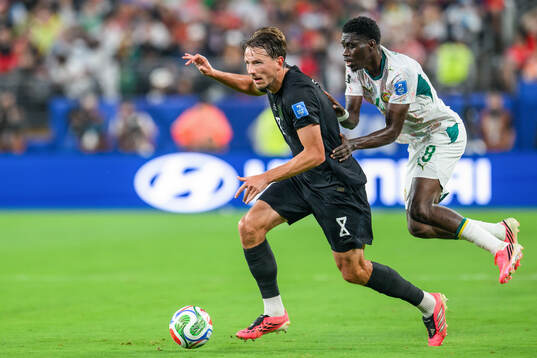 Sander Berge of Norway and Lamine Camara of Senegal