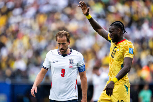 Harry Kane of England and Jerome Opoku of Ghana