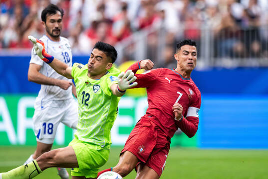 goalkeeper Abduvohid Nematov of Uzbekistan and Cristiano