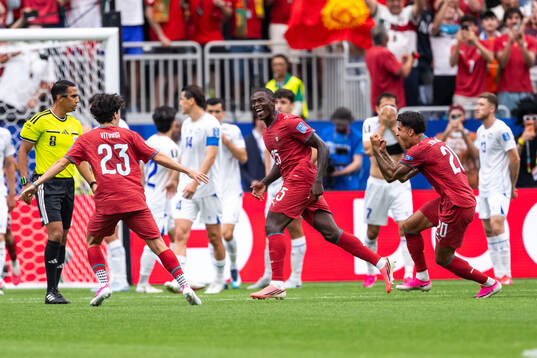 Nuno Mendes of Portugal celebrates with Vitinha and Joao