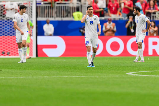 Azizjon Ganiev of Uzbekistan looks dejected