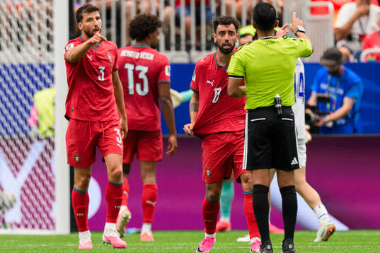 Ruben Dias and Bruno Fernandes of Portugal reacts against