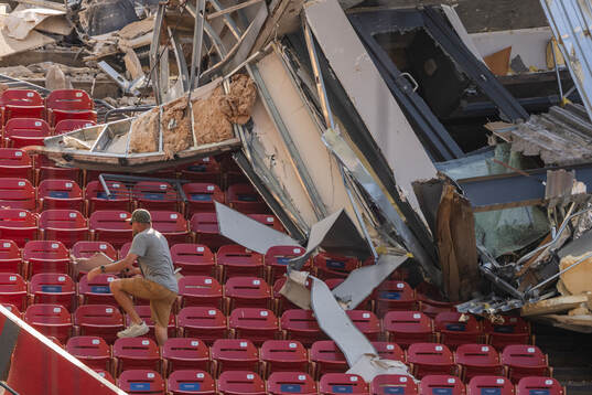 Stadium personnel in the stands bellow