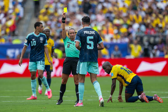 Aleksandar Pavlovic of Germany receives a yellow card from