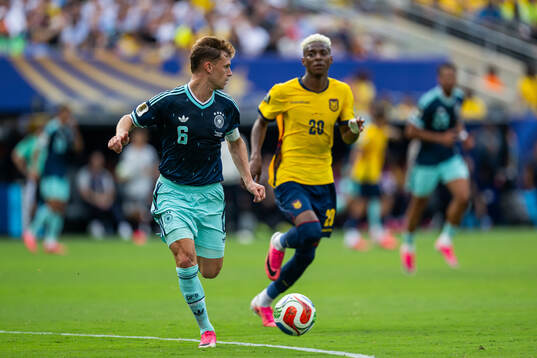 Joshua Kimmich of Germany and Nilson Angulo of Ecuador