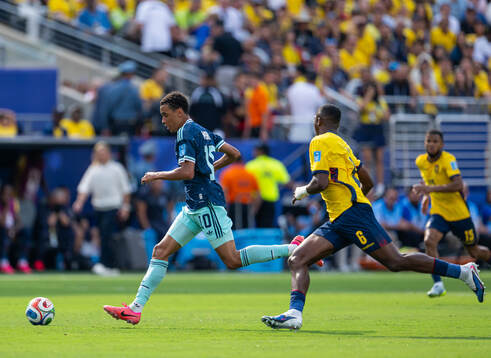 Jamal Musiala of Germany and Willian Pacho of Ecuador