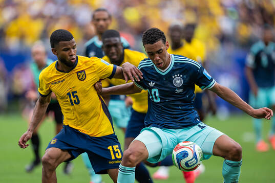 Pedro Vite of Ecuador and Jamal Musiala of Germany