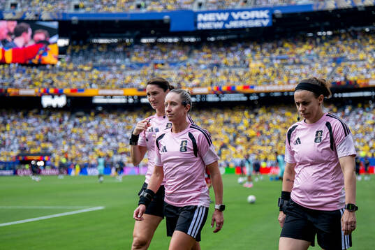 Kathryn Nesbitt, assistant referee, Tori Penso, referee and