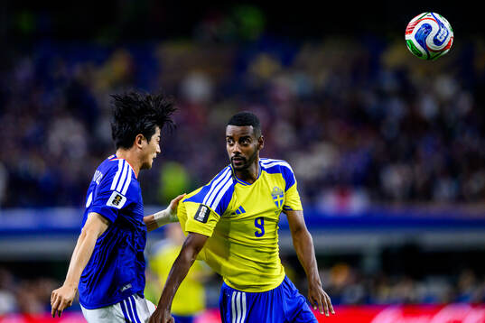 Shogo Taniguchi of Japan and Alexander Isak of Sweden