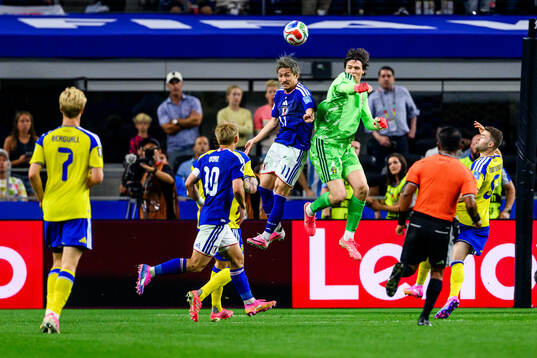 Daizen Maeda of Japan and goalkeeper Jacob Widell