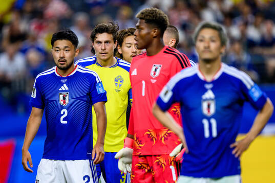 Yukinari Sugawara and goalkeeper Zion Suzuki of Japan and