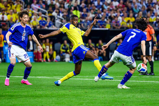Alexander Isak of Sweden and Ao Tanaka of Japan