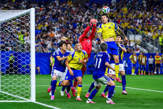 Goalkeeper Zion Suzuki of Japan and Gustaf Lagerbielke and