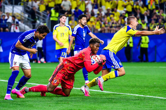 Goalkeeper Zion Suzuki of Japan and Gustaf Lagerbielke of