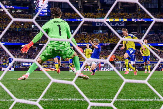 Daizen Maeda of Japan scores 1-0 behind goalkeeper Jacob