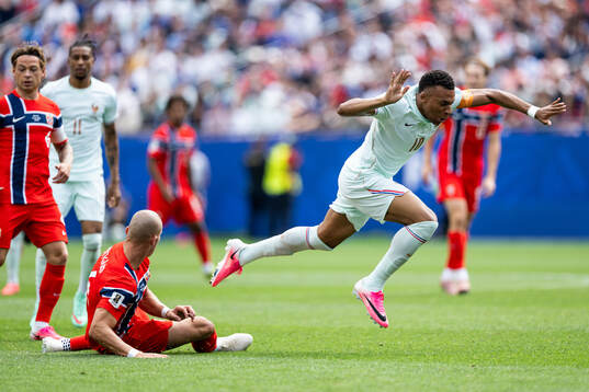 Leo Østigård of Norway and Kylian Mbappe of France