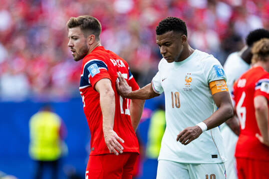 Fredrik André Bjørkan of Norway and Kylian Mbappe of