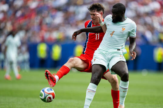 Jørgen Strand Larsen of Norway and Dayot Upamecano of