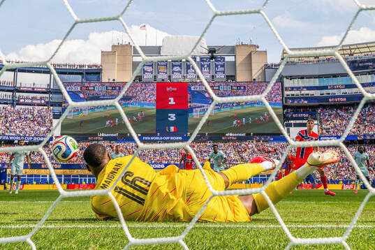 Goalkeeper Mike Maignan of France saves the penalty kick