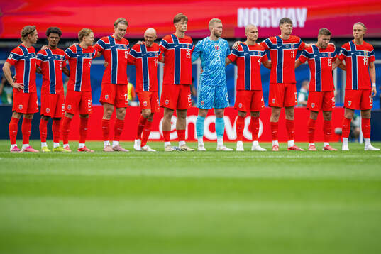 Players of Norway line up for a minute of silence