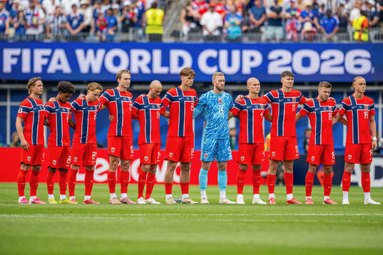 Players of Norway line up for a minute of silence