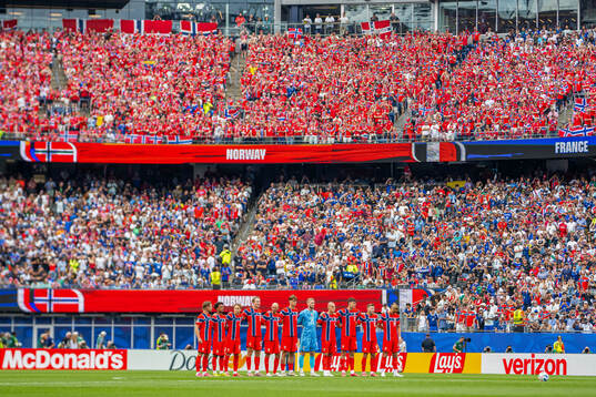 Players of Norway line up for a minute of silence