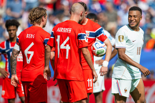 Patrick Berg of Norway and Kylian Mbappe of France