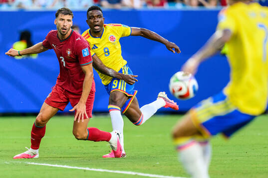 Ruben Dias of Portugal and Jhon Cordoba of Colombia