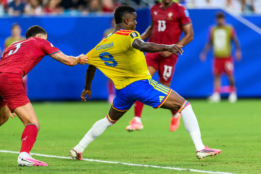 Ruben Dias of Portugal and Jhon Cordoba of Colombia