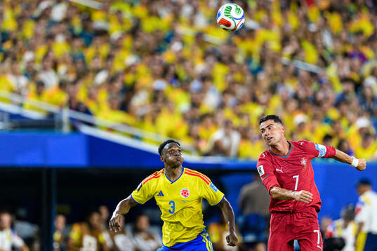 Jhon Lucumi of Colombia and Cristiano Ronaldo of Portugal