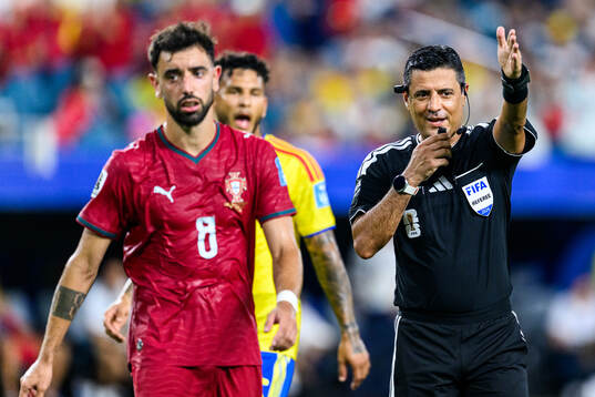 Bruno Fernandes of Portugal and Referee Alireza Faghani
