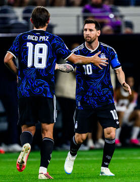 Nico Paz and Lionel Messi of Argentina