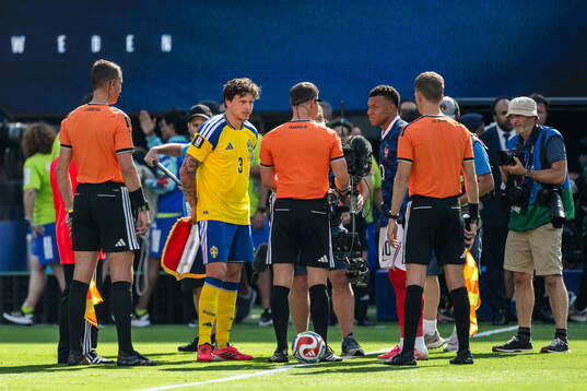 Victor Nilsson Lindelöf of Sweden and Kylian Mbappe of