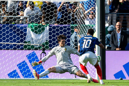 Kylian Mbappe of France and goalkeeper Jacob Widell