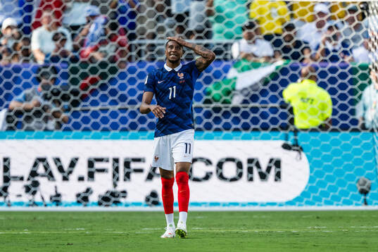 Michael Olise of France looks dejected