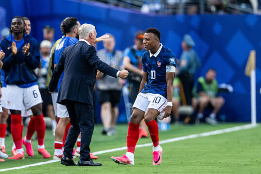 Kylian Mbappe of France celebrates with head coach Didier