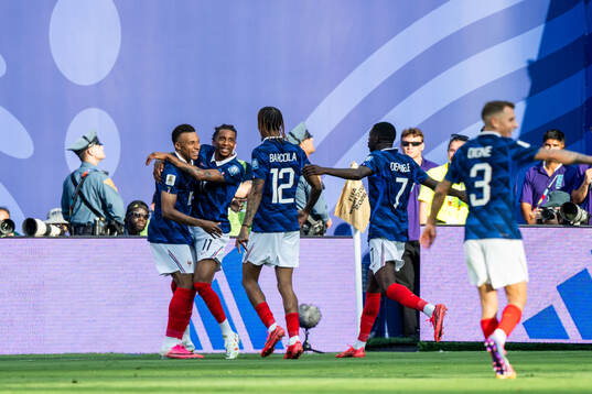 Kylian Mbappe of France celebrates with Michael Olise,