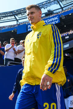 Eric Smith of Sweden enters the pitch