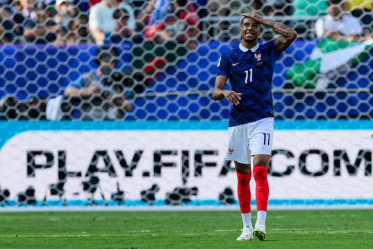 Michael Olise of France looks dejected