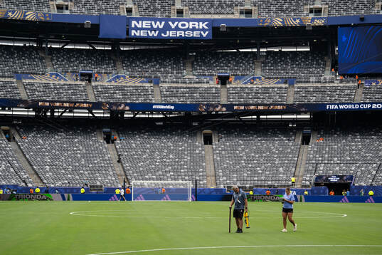Staff observing the pitch at New York New Jersey Arena